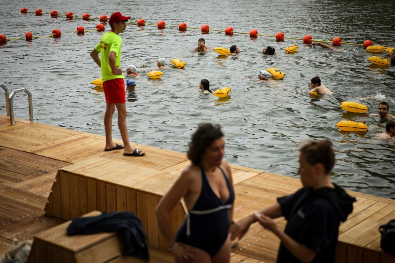 Joyful Parisians take a historic plunge into the Seine after 100 years